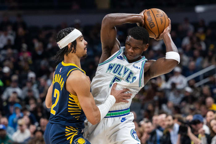 Mar 7, 2024; Indianapolis, Indiana, USA; Minnesota Timberwolves guard Anthony Edwards (5) holds the ball while Indiana Pacers guard Andrew Nembhard (2) defends during the first half at Gainbridge Fieldhouse.